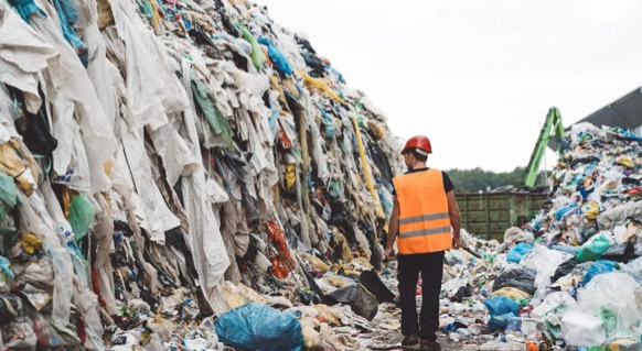 A landfill overflowing with clothing due to fast fashion