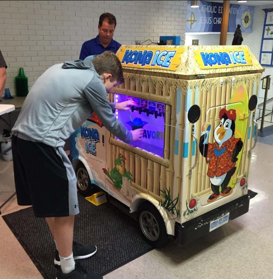 A student choosing flavors to add to his snocone.