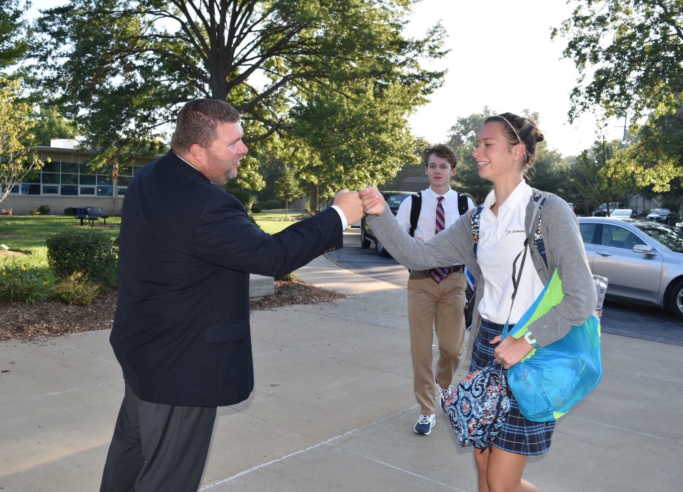 President Welby greeting sophomore Emma Henke with a fistbump.