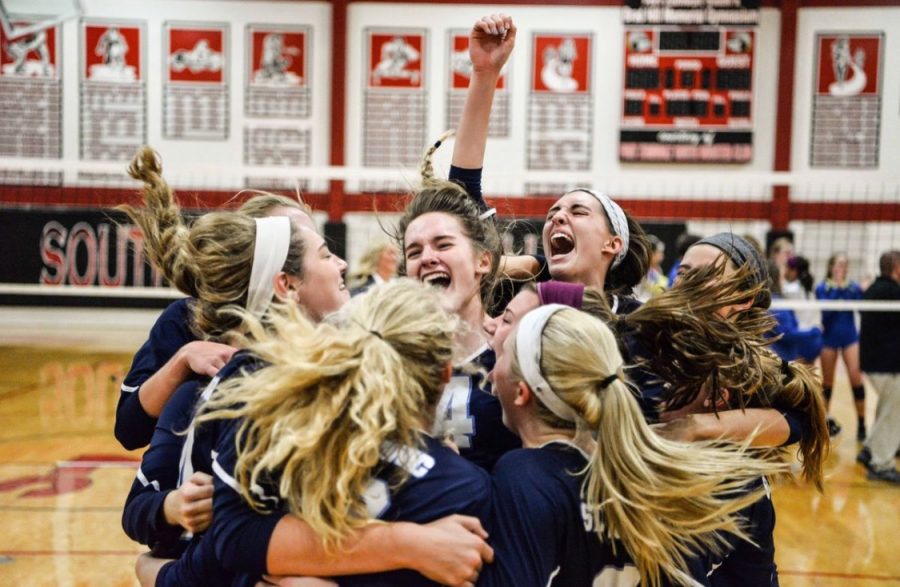 The volleyball team celebrating after defeating Timberland.
