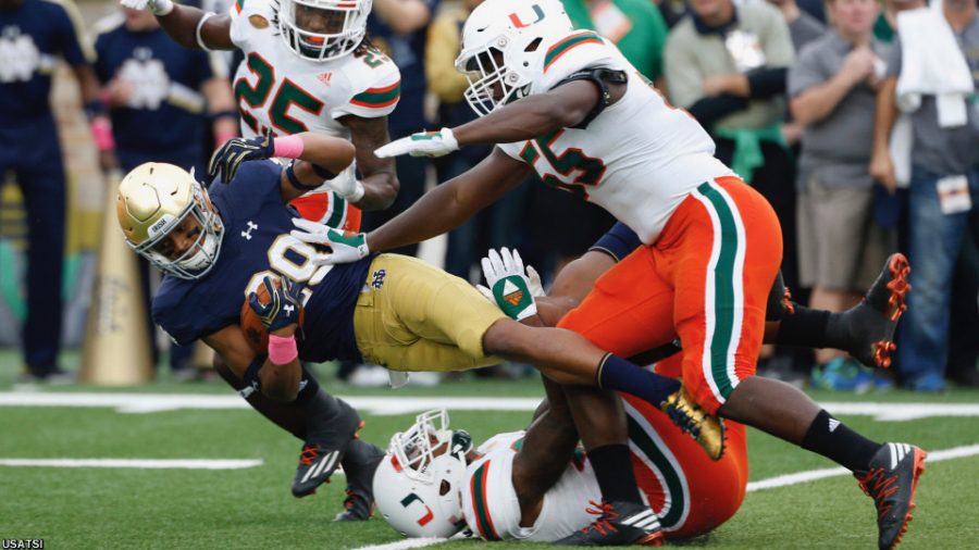 Oct 29, 2016; South Bend, IN, USA; Notre Dame Fighting Irish wide receiver Kevin Stepherson (19) is tackled by Miami Hurricanes linebacker Shaquille Quarterman (55) at Notre Dame Stadium. Mandatory Credit: Brian Spurlock-USA TODAY Sports