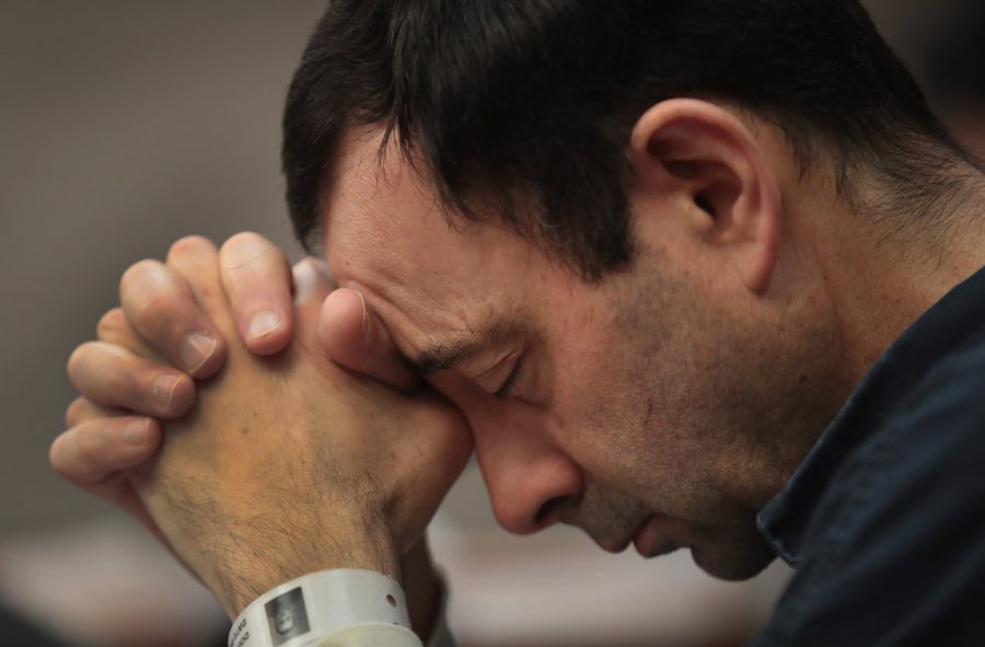 LANSING, MI - JANUARY 16:  Larry Nassar listens to victim impact statements prior to being sentenced after being accused of molesting about 100 girls while he was a physician for USA Gymnastics and Michigan State University, where he had his sports-medicine practice on January 16, 2018 in Lansing, Michigan. Nassar has pleaded guilty in Ingham County, Michigan, to sexually assaulting seven girls, but the judge is allowing all his accusers to speak. Nassar is currently serving a 60-year sentence in federal prison for possession of child pornography.  (Photo by Scott Olson/Getty Images)