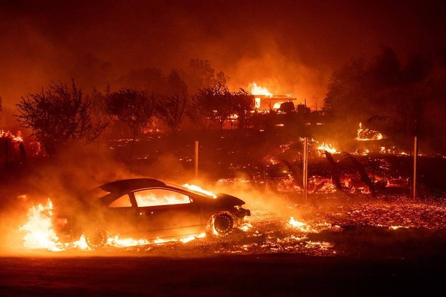 Flames destroy homes and vehicles as the fire tears through Paradise, California on November 8, 2018.