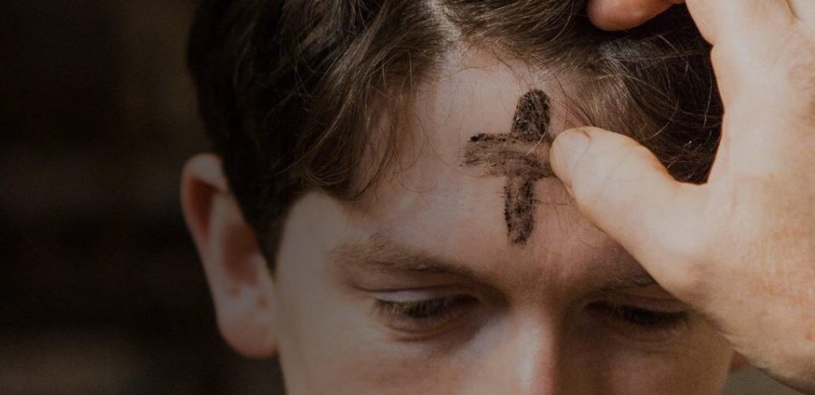Ashes are applied to a man’s forehead during an Ash Wednesday Mass.
