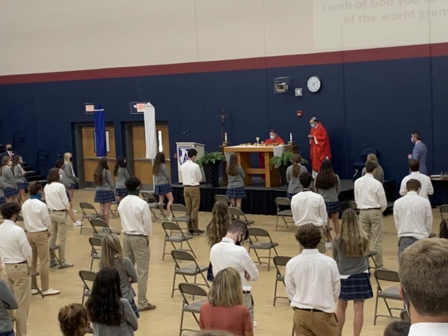Senior students are social distancing while standing for the Eucharistic prayer 