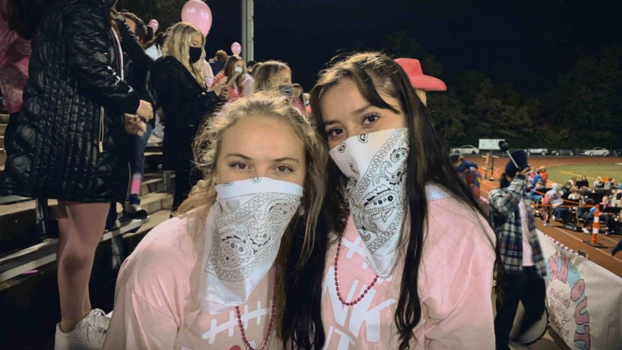 Seniors Katie Donnelly and Natalia Cordero pose in their pink out gear 