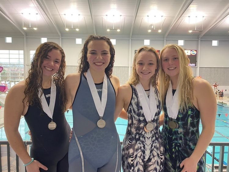 Elise Newman (left), Caroline Cunningham (middle left), Sydney Pickett (middle right), and Kallie Nero (right) win second place in their relay at conference and earn consideration for state. 