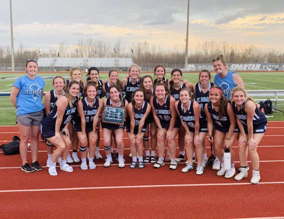 The varsity lacrosse team with the first place tournament plaque 