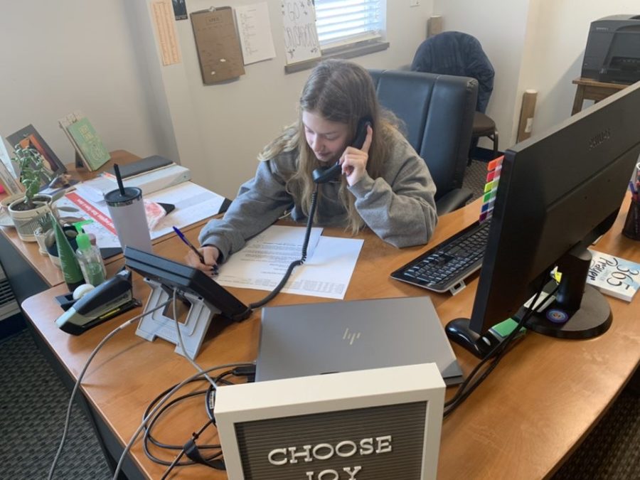 Junior Maddie Poropat calls and thanks one of St. Dominic’s donors. 
