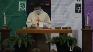 Father Patrick Russell celebrates the Eucharist at the last mass of the school year.