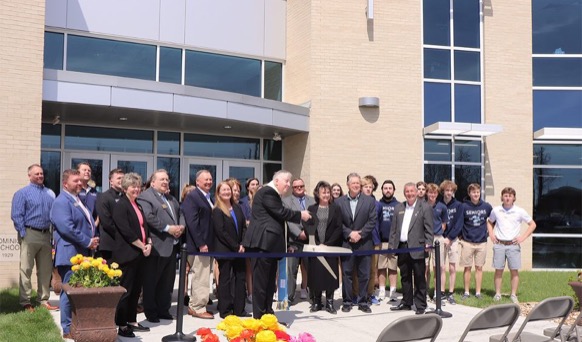 ArchBishop Rozanski cuts the ribbon for the new Center of the Sciences building
