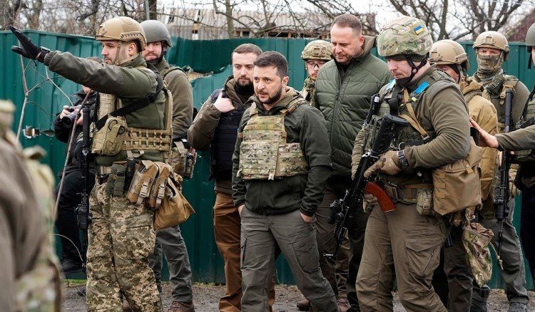 Ukrainian President, Volodymyr Zelenskyy communicates with other Ukrainian military personnel.
