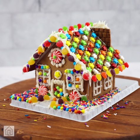 Gingerbread house made with gumdrop, stars, and icing as decorations. 
