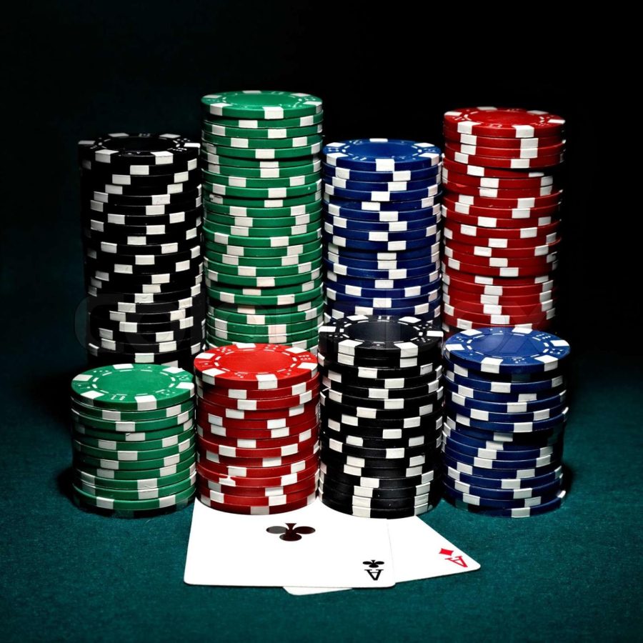 Poker chips used as currency with a pair of aces. 