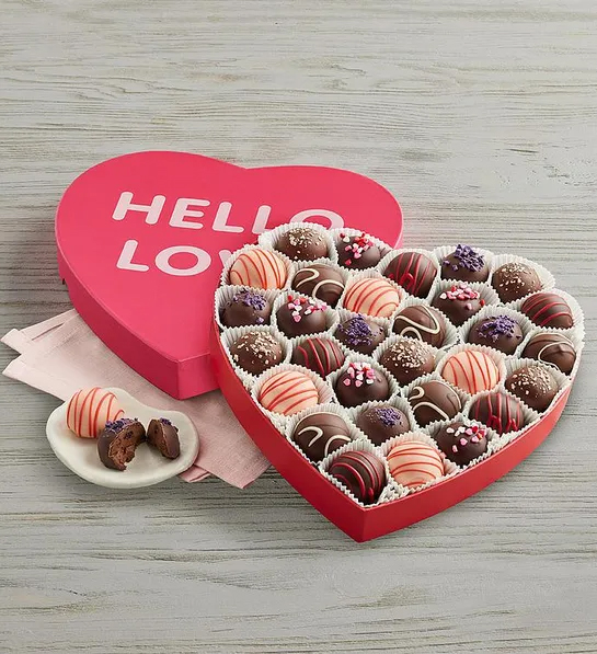 Assorted chocolate candies in a heart shaped Valentines Day box. 
