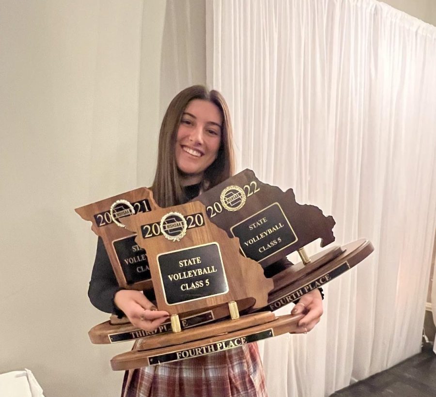 Ella Bland with her multiple state trophies