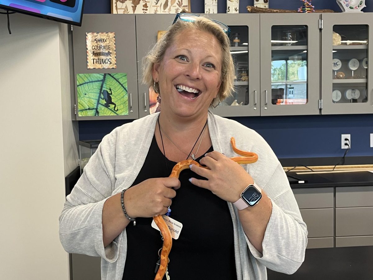 Mrs. McDonald with her new class pet, Penny the snake